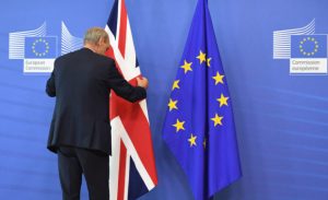 A member of protocol adjusts the British flag prior to the arrival of British Prime Minister David Cameron at EU headquarters in Brussels on Tuesday, June 28, 2016. EU heads of state and government meet Tuesday and Wednesday in Brussels for the first time since Britain voted to leave the European Union, throwing British and European politics into disarray. (AP Photo/Geert Vanden Wijngaert)